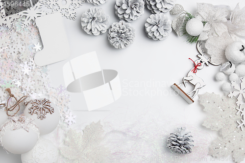 Image of Christmas decorative composition of toys on a white background surrealism. Top view