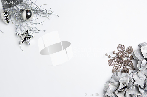 Image of Christmas decorative composition of toys on a white background surrealism. Top view