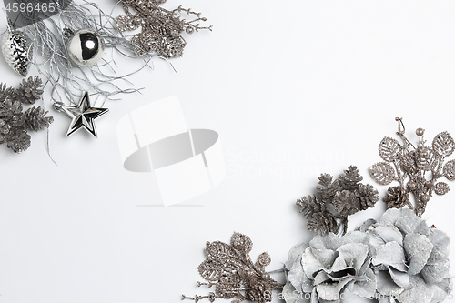 Image of Christmas decorative composition of toys on a white background surrealism. Top view