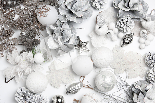 Image of Christmas decorative composition of toys on a white background surrealism. Top view