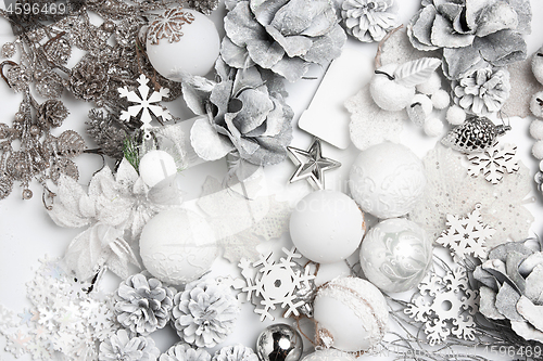 Image of Christmas decorative composition of toys on a white background surrealism. Top view