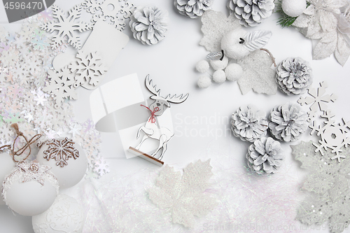 Image of Christmas decorative composition of toys on a white background surrealism. Top view