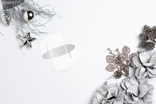 Image of Christmas decorative composition of toys on a white background surrealism. Top view