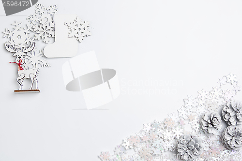 Image of Christmas decorative composition of toys on a white background surrealism. Top view