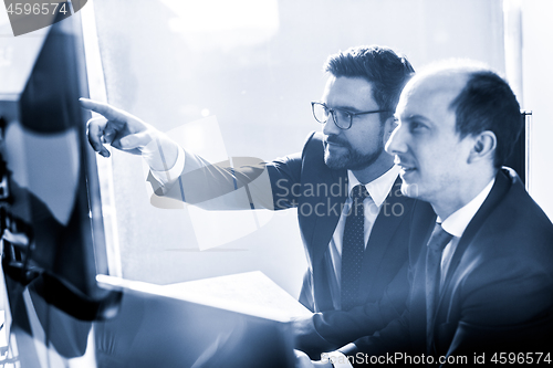 Image of Business team analyzing data at business meeting in modern corporate office.