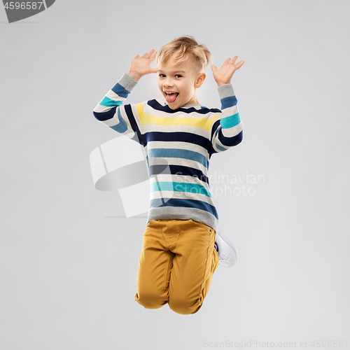 Image of happy little boy jumping and having fun