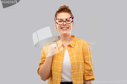 Image of smiling red haired teenage girl with big glasses