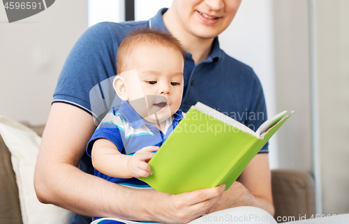 Image of happy father and little baby son with book at home