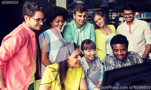 Image of international students with computers at library