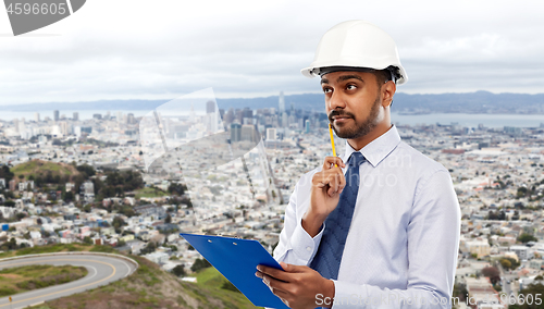 Image of architect or businessman in helmet with clipboard