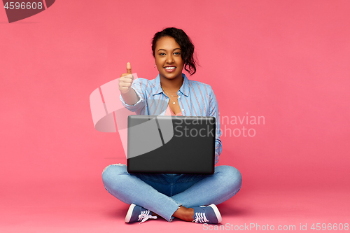 Image of happy african american woman with laptop computer