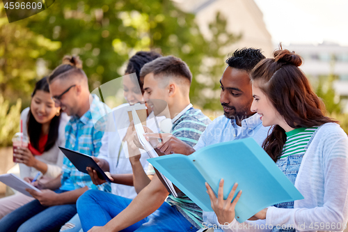 Image of group of happy students with notebooks and drinks