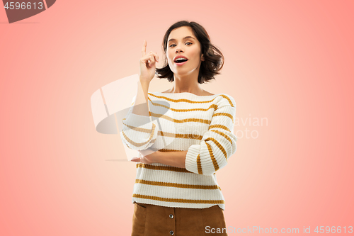 Image of woman in striped pullover pointing her finger up