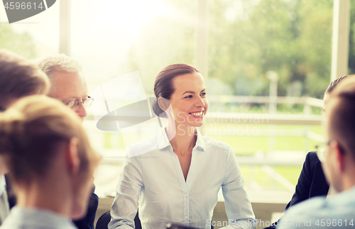 Image of smiling business people meeting in office