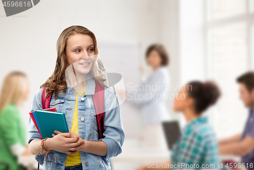 Image of happy smiling teenage student girl with school bag