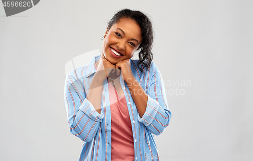 Image of cute african american woman over grey background