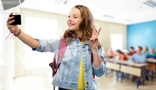 Image of teenage student girl taking selfie by smartphone