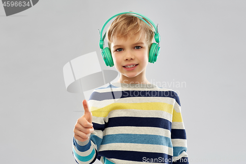Image of boy in headphones showing thumbs up