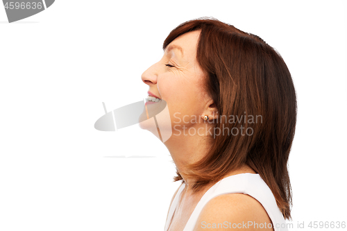 Image of profile of smiling senior woman over white
