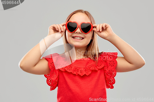 Image of smiling preteen girl with heart shaped sunglasses