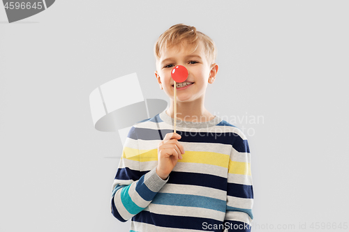 Image of smiling boy with red clown nose party prop