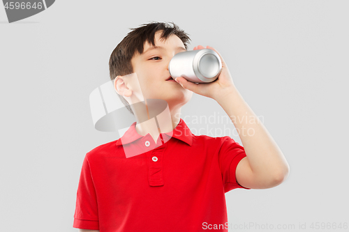 Image of boy in red t-shirt drinking soda from tin can