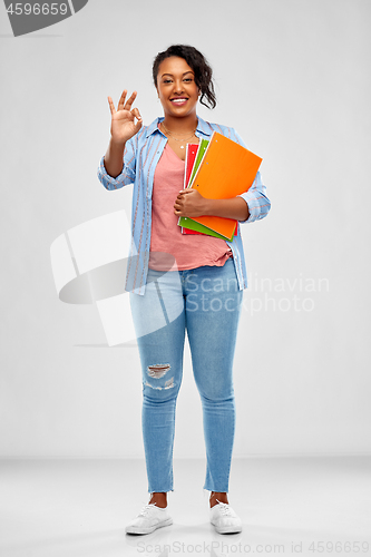 Image of african american student woman with notebooks