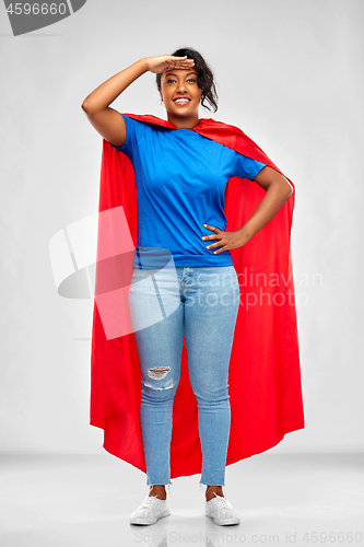 Image of african american superhero woman looking far away