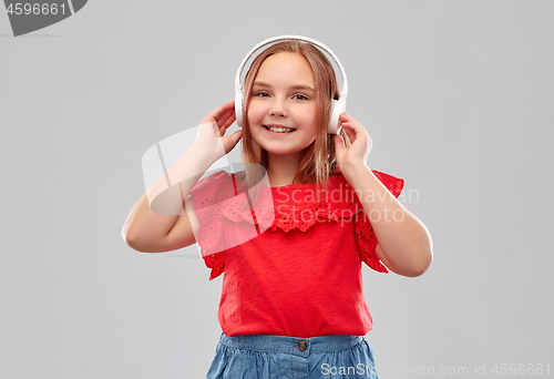 Image of smiling girl in headphones listening to music