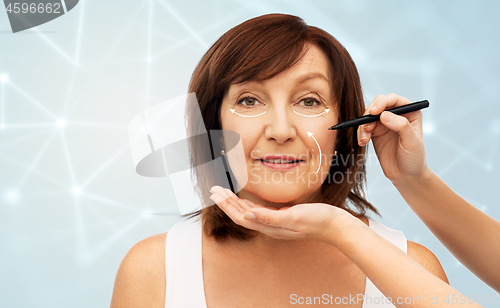 Image of senior woman and hands with cosmetic marker
