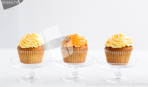 Image of cupcakes with frosting on confectionery stands