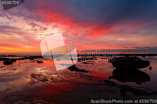 Image of Sunrise seascape at low tide with vivid reflections