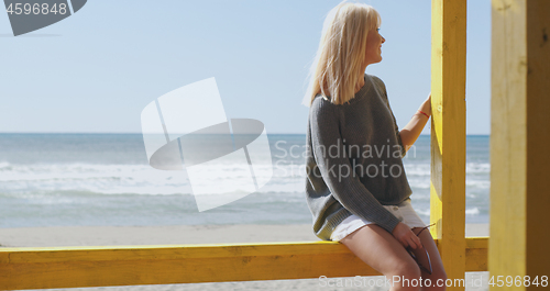 Image of Young woman enjoying the warm autumn day