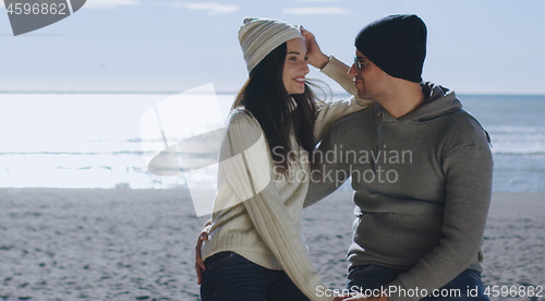 Image of Couple having fun on beautiful autumn day at beach