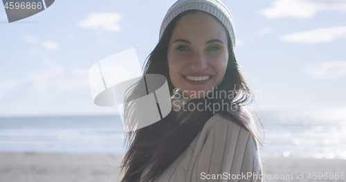 Image of Girl In Autumn Clothes Smiling on beach