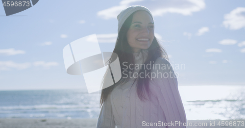 Image of Girl In Autumn Clothes Smiling on beach