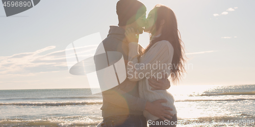 Image of Couple having fun on beautiful autumn day at beach