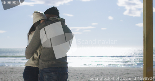 Image of Couple having fun on beautiful autumn day at beach