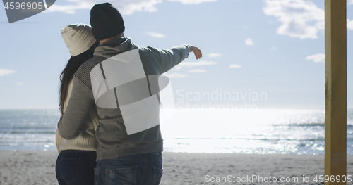 Image of Couple having fun on beautiful autumn day at beach