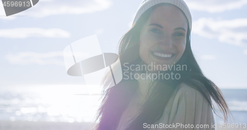 Image of Girl In Autumn Clothes Smiling on beach