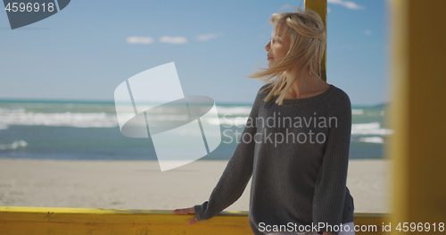 Image of Young woman enjoying the warm autumn day