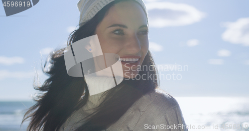 Image of Girl In Autumn Clothes Smiling on beach