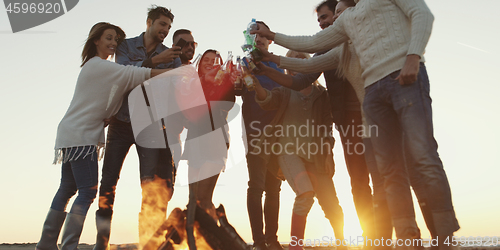 Image of Friends on beach party drinking beer and having fun