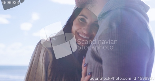 Image of Couple having fun on beautiful autumn day at beach