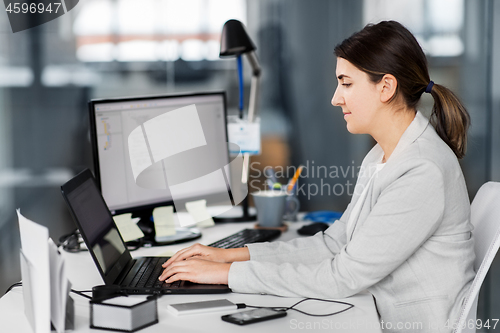 Image of businesswoman with computer working at office