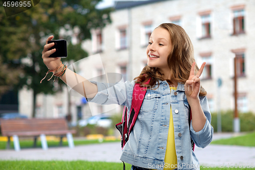 Image of teenage student girl taking selfie by smartphone