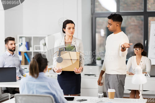 Image of fired sad female office worker leaving