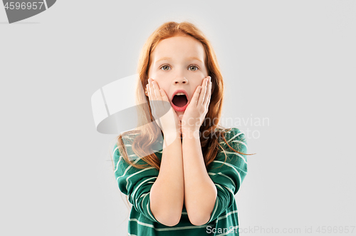Image of shocked red haired girl in with open mouth