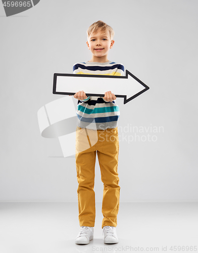 Image of boy holding big white rightwards thick arrow