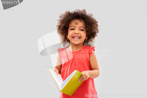 Image of happy little african american girl with book